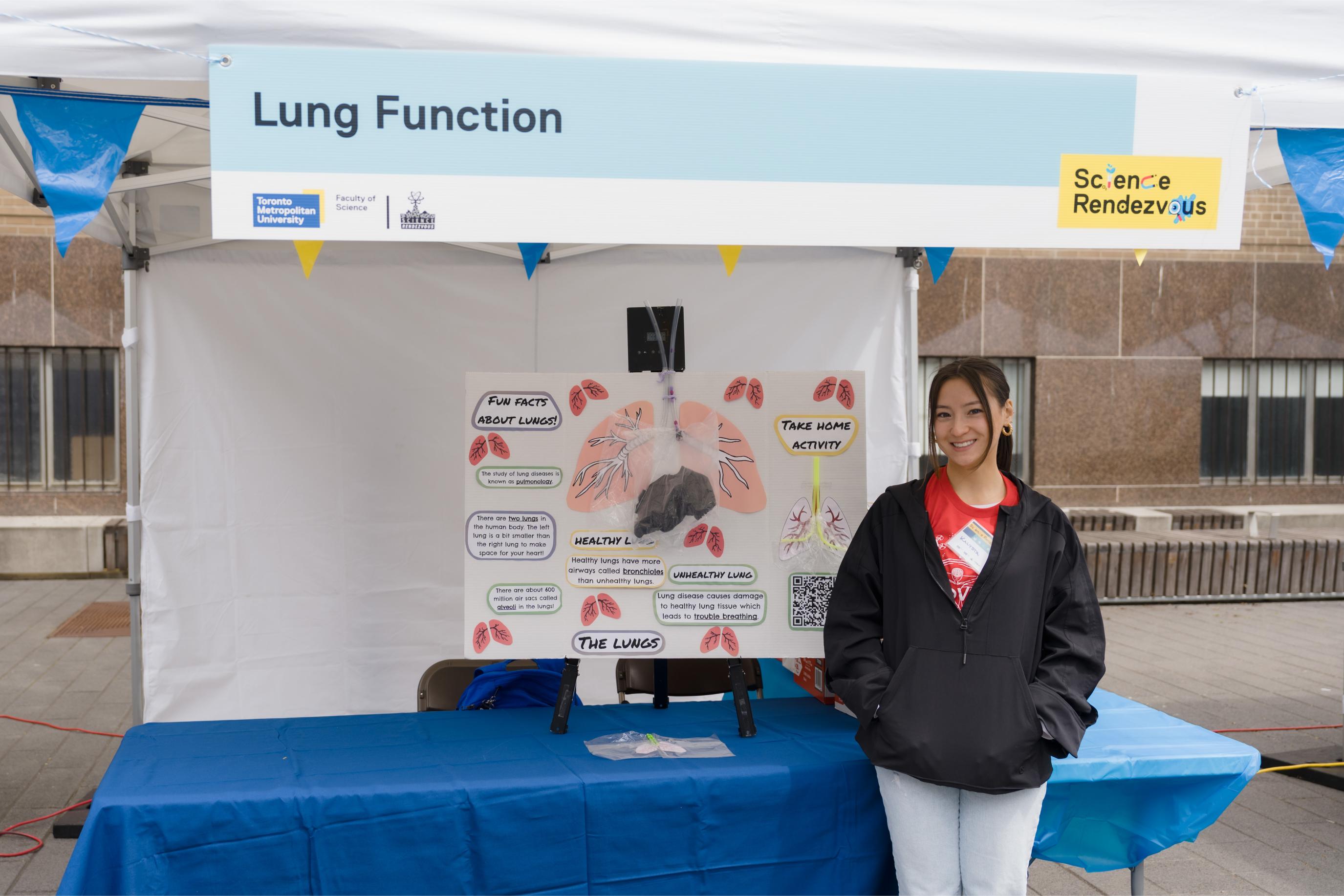 Volunteer posing at the Lung Function Booth
